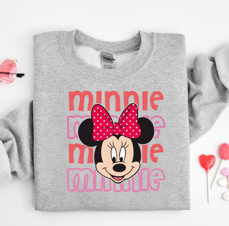 A gray sweatshirt with a Minnie Mouse design and the text "Minnie Minnie" printed on it.