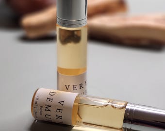 May include: Two small glass bottles of perfume with silver roll-on tops. The bottles are labeled "VERY DEMURE" and "VERY", with the text "Perfume" and "10 ml - .34 fl oz" on the label.