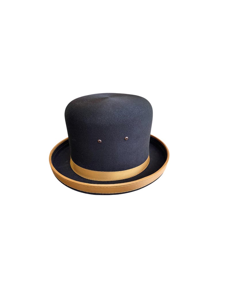 May include: A black felt bowler hat with a brown leather band.