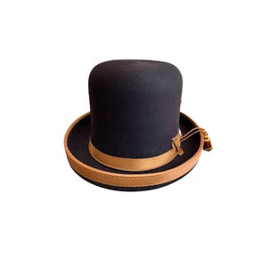 May include: A black felt top hat with a brown leather band and a gold tassel.