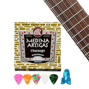 May include: A box of Medina Artigas Charango strings with a fretboard in the background. The box is gold with black and red text. Six colorful guitar picks are in front of the box, including pink, orange, green, white, and blue.