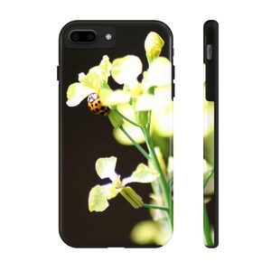 May include: A close-up of a ladybug on a yellow flower. The flower is in focus, while the background is blurred.