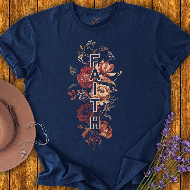 May include: A navy blue t-shirt with a floral design and the word "FAITH" printed vertically in the center.