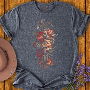 May include: A dark blue t-shirt with a floral design and the word "FAITH" printed vertically in the center.