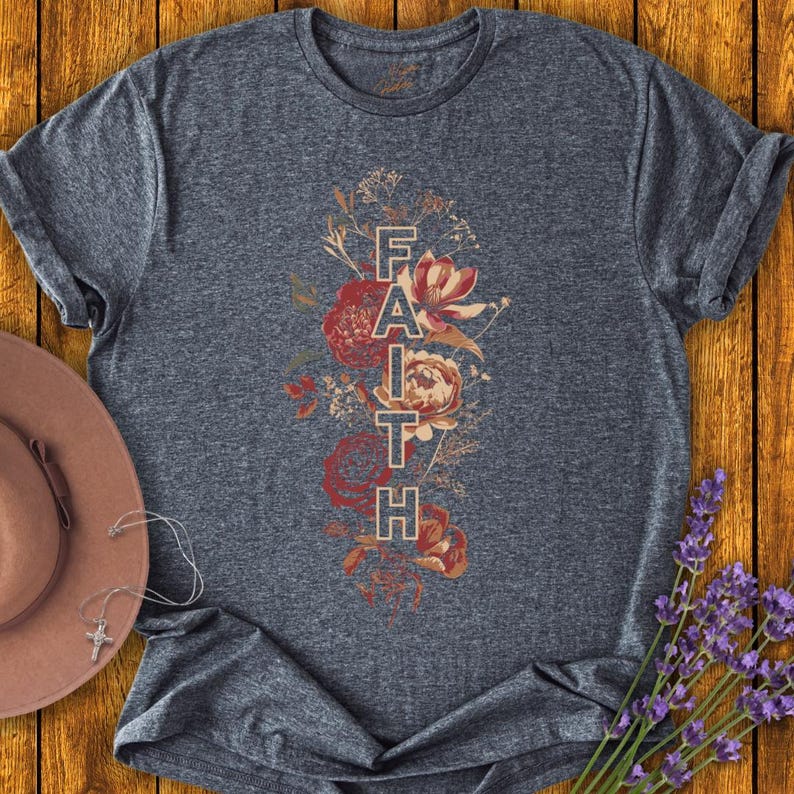 May include: A dark blue t-shirt with a floral design and the word "FAITH" printed vertically in the center.