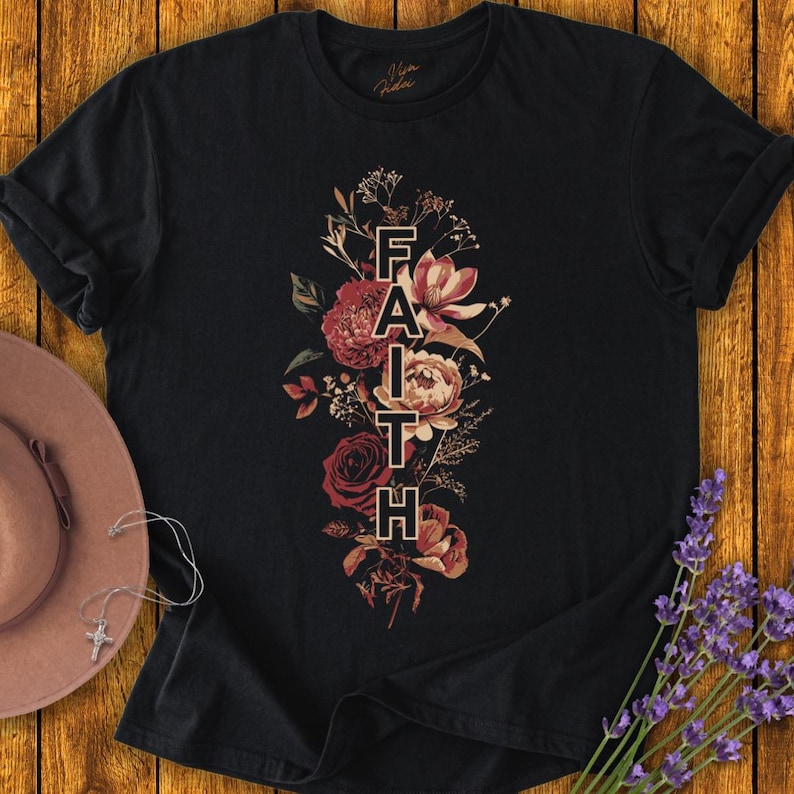May include: Black t-shirt with a floral design and the word "FAITH" in a vertical line.