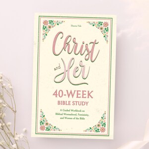 May include: A book cover with a floral design and the title "Christ and Her 40-Week Bible Study: A Guided Workbook on Biblical Womanhood, Femininity, and Women of the Bible".