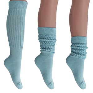 May include: Three pairs of light blue slouch socks. The socks are made of a soft, stretchy fabric and have a ribbed texture. The socks are folded down at the top, creating a slouchy look.