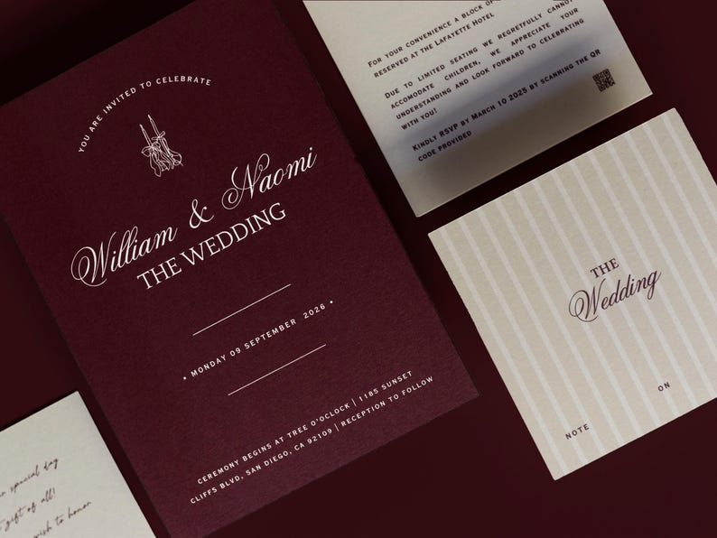 May include: Burgundy wedding invitation suite with white calligraphy. The main invitation reads "William & Naomi THE WEDDING" with the date and location. Additional cards include RSVP information and a note card. Elegant design.