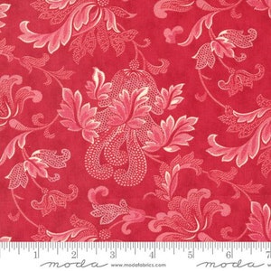 May include: Red fabric with a white floral pattern. The fabric has a vintage look and feel. The pattern is a repeating design of flowers and leaves.