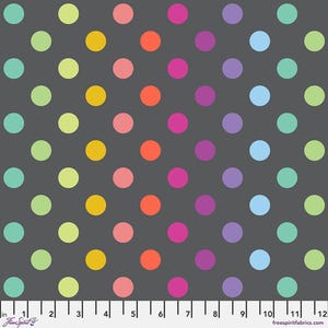 May include: A fabric with a dark gray background and a repeating pattern of colorful polka dots. The dots are in shades of pink, orange, yellow, green, blue, and purple. The fabric has a ruler along the bottom edge, with measurements in inches.