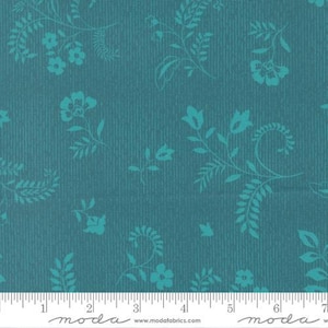 May include: Teal fabric with a vertical ribbed texture and a repeating pattern of stylized turquoise floral and leaf designs. The fabric is suitable for quilting, sewing, or crafting projects. The image includes a ruler along the bottom edge.