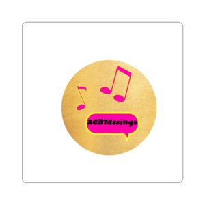 May include: A round sticker with a gold background featuring three pink musical notes. A pink speech bubble contains the text "ACBTdesings" in black. The sticker is likely for music-related products.