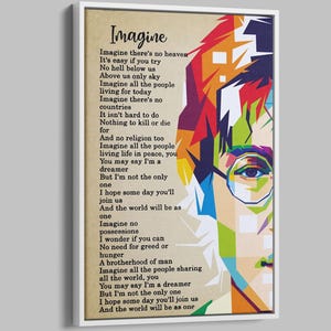 Op de afbeelding: Een ingelijste kunstdruk met een kleurrijk pop-art portret van een persoon met een bril, gecombineerd met de tekst van het nummer "Imagine" van John Lennon. Het kunstwerk heeft een witte rand en een neutrale achtergrond.