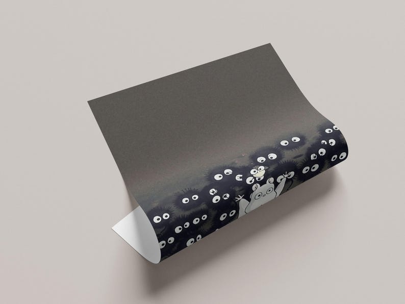 May include: A rolled-up print featuring a whimsical illustration of soot sprites and a friendly forest spirit. The artwork showcases a dark, textured background with white-eyed soot sprites and a light-colored spirit.