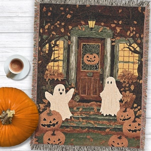 Halloween woven throw blanket – spooky porch ghosts and pumpkins – cozy fall decor, jack-o’-lantern tapestry, whimsical Halloween throw