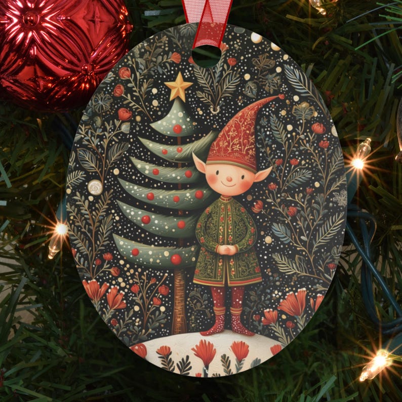 May include: Oval Christmas ornament featuring a whimsical elf standing next to a decorated Christmas tree. The ornament has a dark background with floral and star details. The elf wears a red hat and green coat. A red ribbon is attached for hanging.