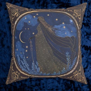 May include: Square decorative pillow featuring a celestial design. The pillow has a dark brown border with gold accents. The center design depicts a woman in a flowing gown, holding a staff, under a starry night sky with a crescent moon.