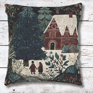 May include: Square decorative pillow with a tapestry design featuring a winter scene. The image shows a house with a snow-covered roof, trees, and two figures holding hands. The color palette includes shades of blue, green, and brown.