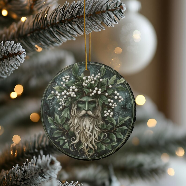 May include: A round ceramic ornament with a green man figure wearing a crown of holly and white berries. The background is a dark green and blue with a starry effect.