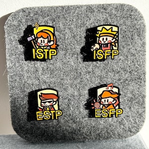 May include: Four enamel pins with cartoon characters representing personality types: ISTP, ISFP, ESTP, and ESFP. Each pin features a unique character design with a yellow border and the corresponding personality type abbreviation.