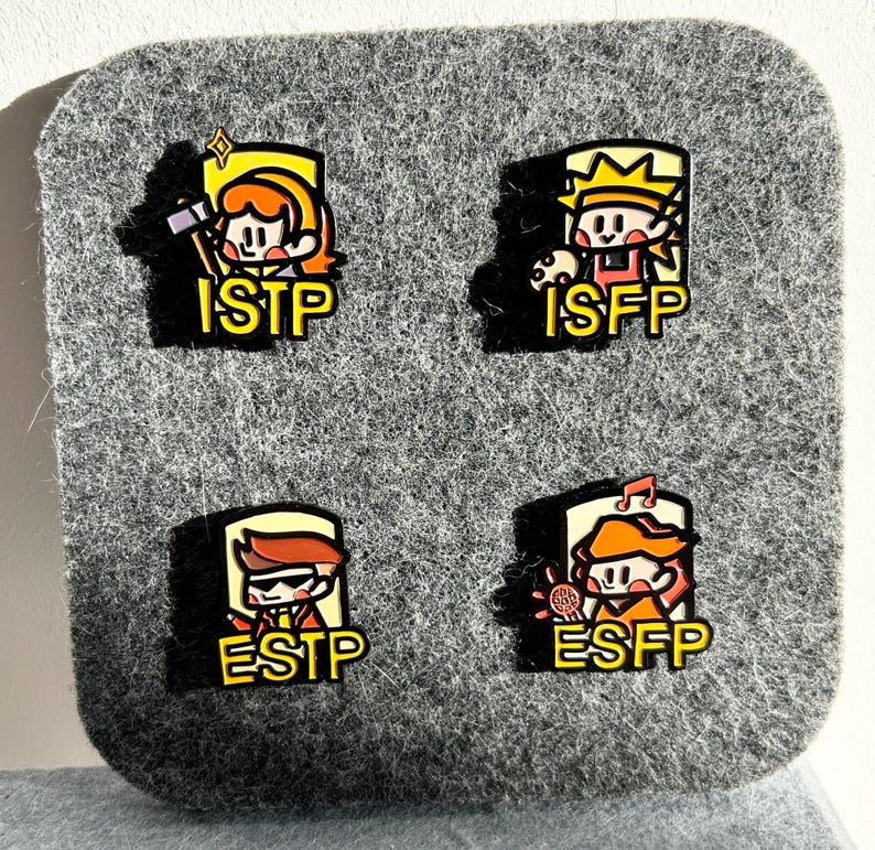 May include: Four enamel pins with cartoon characters representing personality types: ISTP, ISFP, ESTP, and ESFP. Each pin features a unique character design with a yellow border and the corresponding personality type abbreviation.