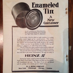 May include: A vintage advertisement for Heinz 57 Enameled Tin, featuring a close-up of two open tins. The text highlights the benefits of the enamel coating, which protects the food from contact with the tin, preventing corrosion and discoloration. The ad also mentions that the tins are crimped, eliminating the need for solder. The text emphasizes the benefits of the Heinz Improved Tin, including its ability to be sterilized without breakage and its ability to preserve the freshness and flavor of the food.