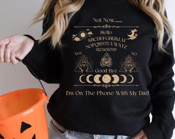 Ouija Board Sweatshirt Not Now... Im On The Phone With My Dad Ouija Board Crewneck Sweatshirt | Funny Spiritual Graphic | Unisex Heavy Blend
