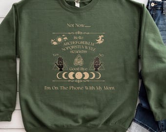 Ouija Board Sweatshirt Not Now... Im On The Phone With My Mom Ouija Board Crewneck Sweatshirt | Funny Spiritual Graphic | Unisex Heavy Blend