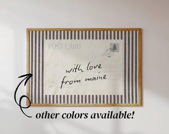 May include: A rectangular wall art piece featuring a postcard design with the handwritten text 'with love from maine' centred on a cream background. The postcard is framed by a border of vertical dark grey and white stripes in a wooden frame.