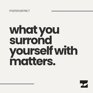 May include: A square poster with a light cream background and black text. The text reads "POSTER DISTRICT" at the top left, "what you surrond yourself with matters." in the center, and a small black square logo with white shapes at the bottom right.