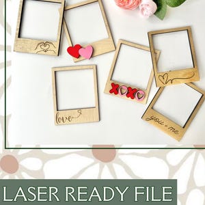 May include: Wooden polaroid-style frames with decorative elements. Some frames have laser-cut designs like hearts, the word "love", and "XOXO". Red and pink heart accents are also included. The phrase "you + me" is also visible.
