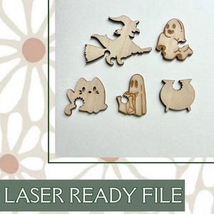 May include: A collection of laser-cut wooden Halloween-themed shapes. The shapes include a witch on a broom, a ghost, a cat, another ghost, and a cauldron. The text "LASER READY FILE" is at the bottom.
