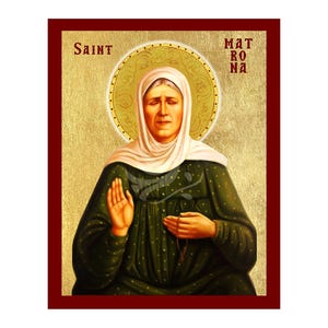 May include: An icon of Saint Matrona, featuring a woman in a white head covering and a green dress with gold dots. The image has a gold halo and the word "Saint" is at the top left. The name "Matrona" is at the top right.