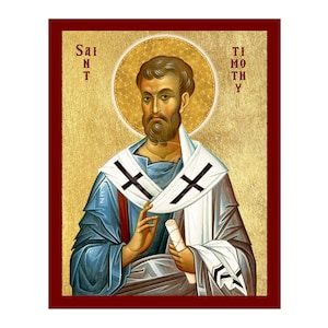 May include: An icon of Saint Timothy, framed in a dark red border. The image features a man with a beard, wearing blue and white robes with black crosses. The background is gold with the words "SAINT" and "TIMOTHY" on either side.