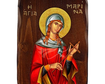 May include: A wooden icon of Saint Mary with a gold halo and a red robe. The icon is painted in a traditional style and features the text "Η ΑΓΙΑ" and "ΜΑΡΙ ΝΑ".