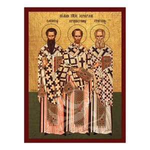 Op de afbeelding: Een icoon met drie figuren, Basilius, Johannes Chrysostomus en Gregorius, met de tekst "οἱ ἅγιοι τρεῖς ἱεράρχαι" (De Heilige Drie Hiërarchen) erboven.
