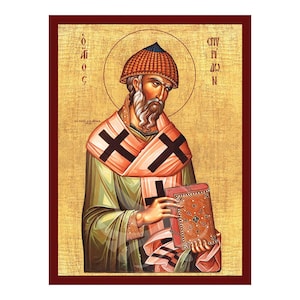 May include: An icon of Saint Pius the Tenth, a religious figure, depicted in a traditional Byzantine style. He is wearing a red and gold hat and a green robe with a white and red sash. He is holding a book in his left hand and has a cross on his chest. The background is gold with a halo around his head.