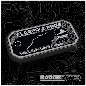 May include: A black and silver badge-shaped patch with the text "FLAGPOLE KNOB" and "GEORGE WASHINGTON NATIONAL FOREST, VA". The patch also features a map of the trail, the state of Virginia, and the text "TRAIL EXPLORED" and "BADGERATED.COM".