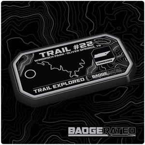 May include: A black and white Trail #22 badge with a map of Tennessee and the text "Trail Explored." The badge features the text "Windrock Park, Oliver Springs, TN" and the Badgerated logo.