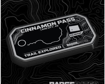 May include: A black and white trail badge with the text "Cinnamon Pass, Lake City, CO" and "Trail Explored" with a map of the trail and the state of Colorado. The badge is made by BadgeRated.