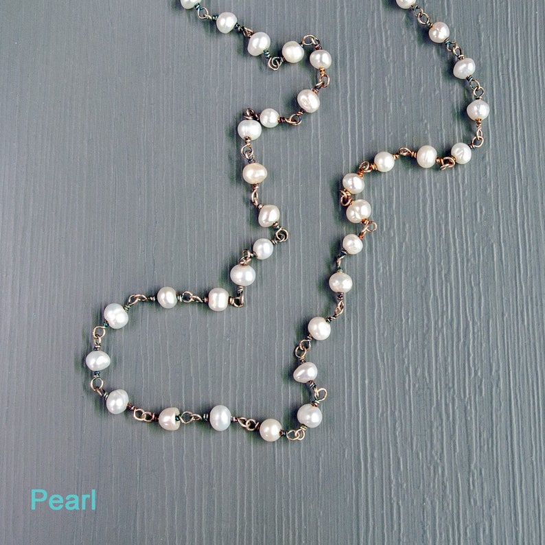 May include: A pearl necklace with a silver chain. The pearls are white and round.