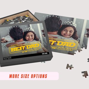 May include: A personalized 8x10 puzzle featuring a photo of a father and daughter with the text "The Best Dad in the Galaxy" in a yellow Star Wars-inspired font. The puzzle is in a black box with a white background.