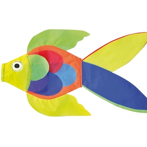 May include: A colourful fish-shaped windsock with a yellow, green, blue and red design. The windsock has a white tail and a black eye.
