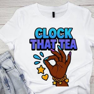 May include: White t-shirt with the text "CLOCK THAT TEA" in blue and purple. The graphic features a brown hand with blue and purple nails, making an "okay" gesture, with water droplets, a star, and a heart.