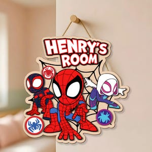 May include: A wooden wall sign featuring the text HENRY'S ROOM in bold red letters. The design includes three cartoon spider-themed characters in red, blue, black, and white, set against a black spiderweb background with circular spider icons.