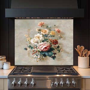 May include: A floral backsplash featuring a vintage-style bouquet of pink, red, yellow, and white roses and other flowers. The flowers are set against a light green and gray marble-like background. The backsplash is above a stainless steel gas range.