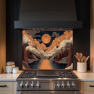 May include: A kitchen backsplash featuring a landscape painting with a large orange moon, mountains, and a river. The artwork is framed by a black range hood and set above a stainless steel gas range.
