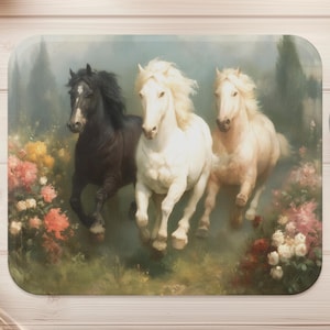 May include: Three horses running through a field of flowers. The horses are white, black, and white with a black mane. The flowers are pink, red, and yellow.