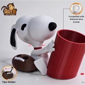 May include: A white Snoopy figurine with black ears and nose, holding a red glue stick holder and a brown football. The holder is compatible with different glue brands. A small brown tips holder is also included.